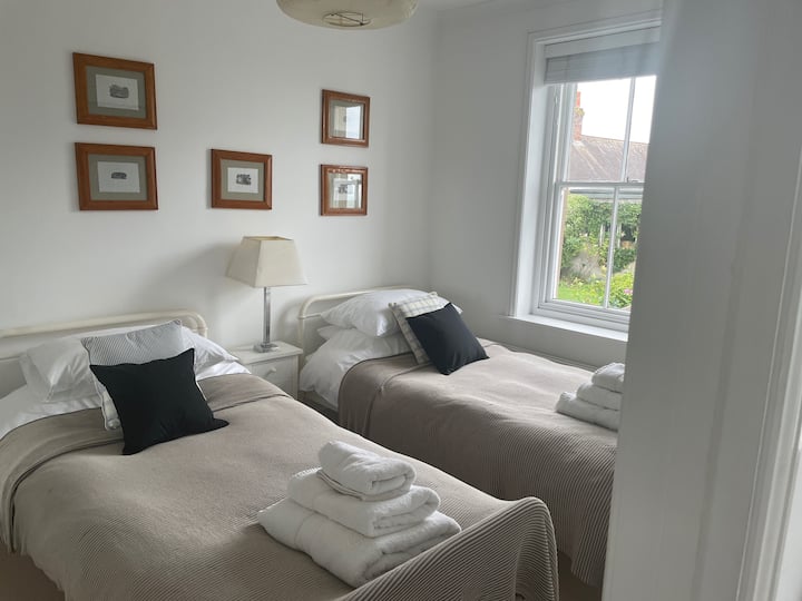 The charming twin bedroom off the reading room.