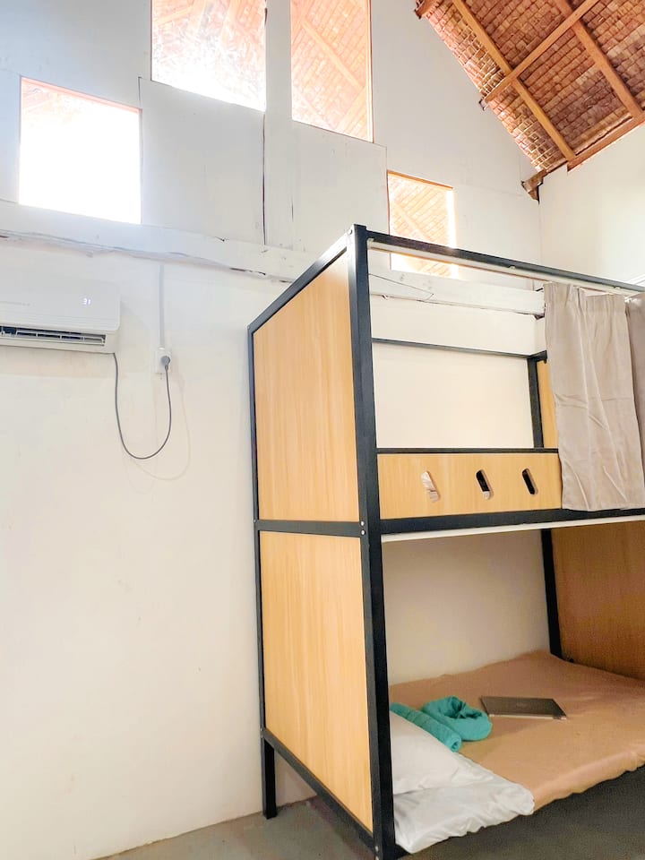 Bunk beds in a shared room at OK Surf Hostel, General Luna