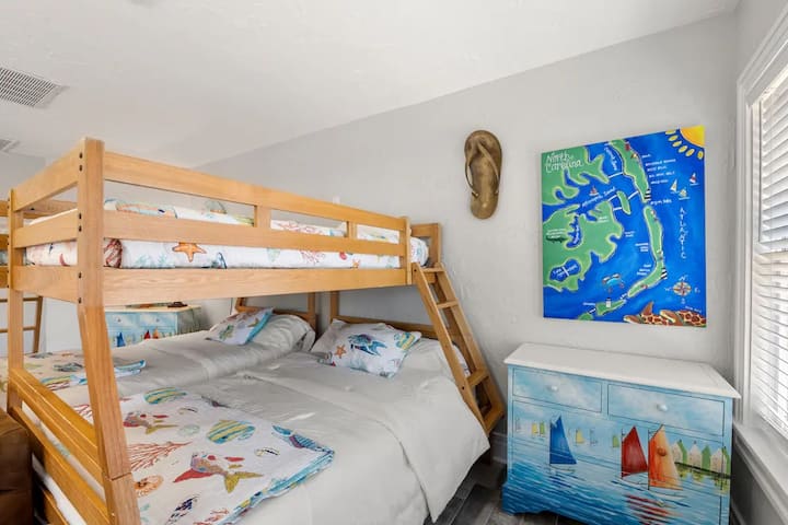 Large bunk room features two pyramid bunks, couch and large tv, air hockey table, & shuffleboard table. Perfect for teens or anyone who wants to feel young at heart! 