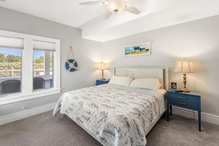 Large private King bedroom overlooks the pool deck and offers easy access to the kitchenette/barcade area, adjacent bathroom access, and is just steps from the hot tub for late night dips!