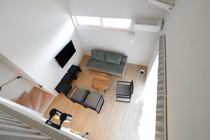 Living room with white entrance door
West