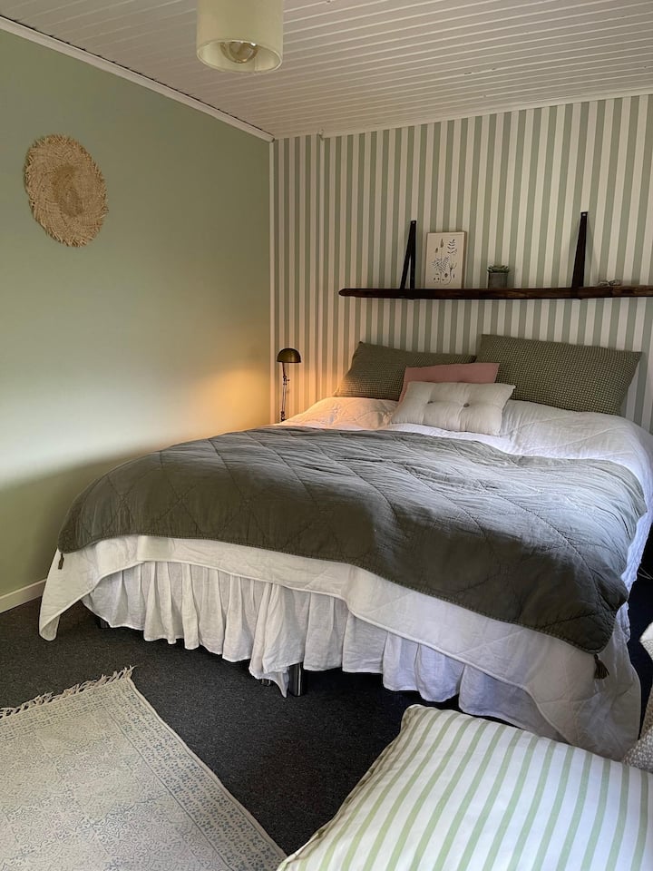 The green bedroom with a double bed