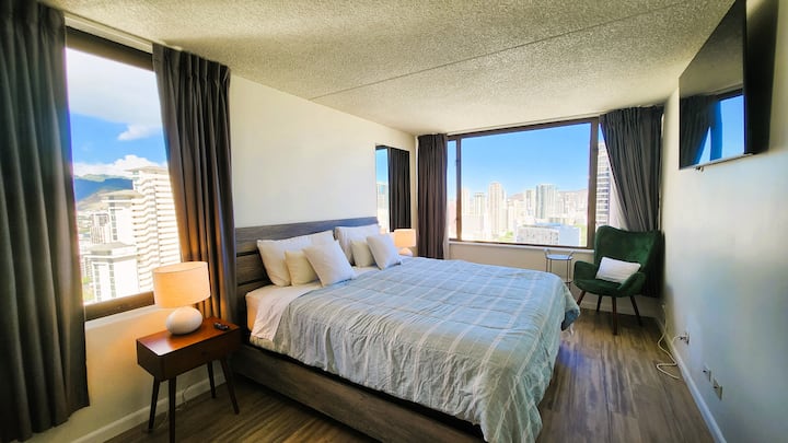 King-size bed with extra windows for view and well-lit comfortable environment