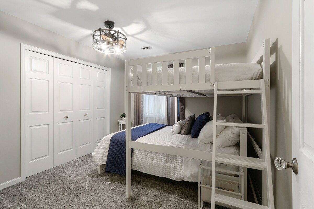 2nd floor bunk room with Full over Queen beds, closet, and ceiling fan.