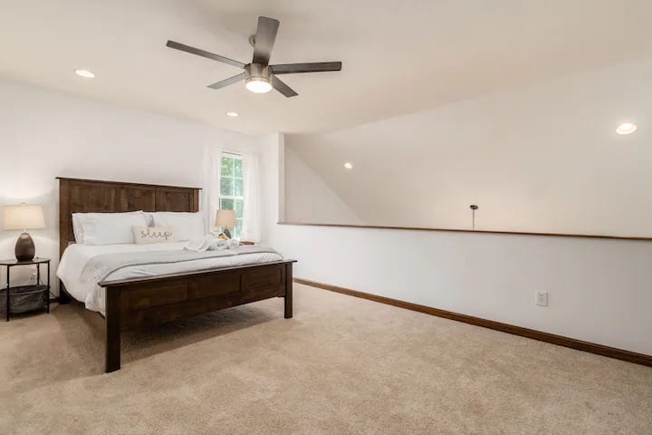 Este acogedor dormitorio se encuentra sobre la sala de estar, creando un ambiente cálido y acogedor. 