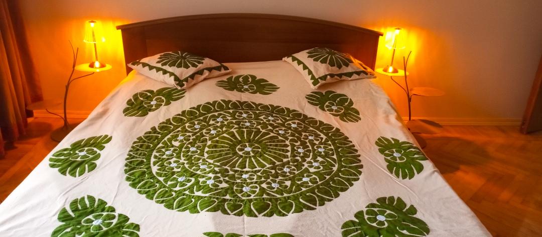 سرير مزدوج مع رفوف بجانب السرير من المصابيح الليلية التي تغير لون الإضاءة وتعمل على بطارية شحن.  يوجد منفذ بجانب السرير لشحن هاتفك