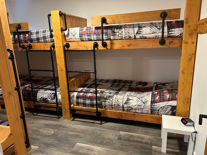 Upstairs bunk room with 6 Twins beds. Hooks and shelving for luggage/bags.