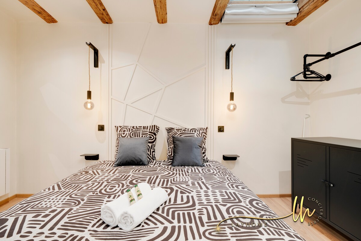 Habitación con una losa de vidrio en el techo para una máxima claridad, complementada con una persiana opaca para una oscuridad total. Un perchero de pared y un mueble de almacenamiento metálico de estilo industrial, agregan un toque práctico y estético.