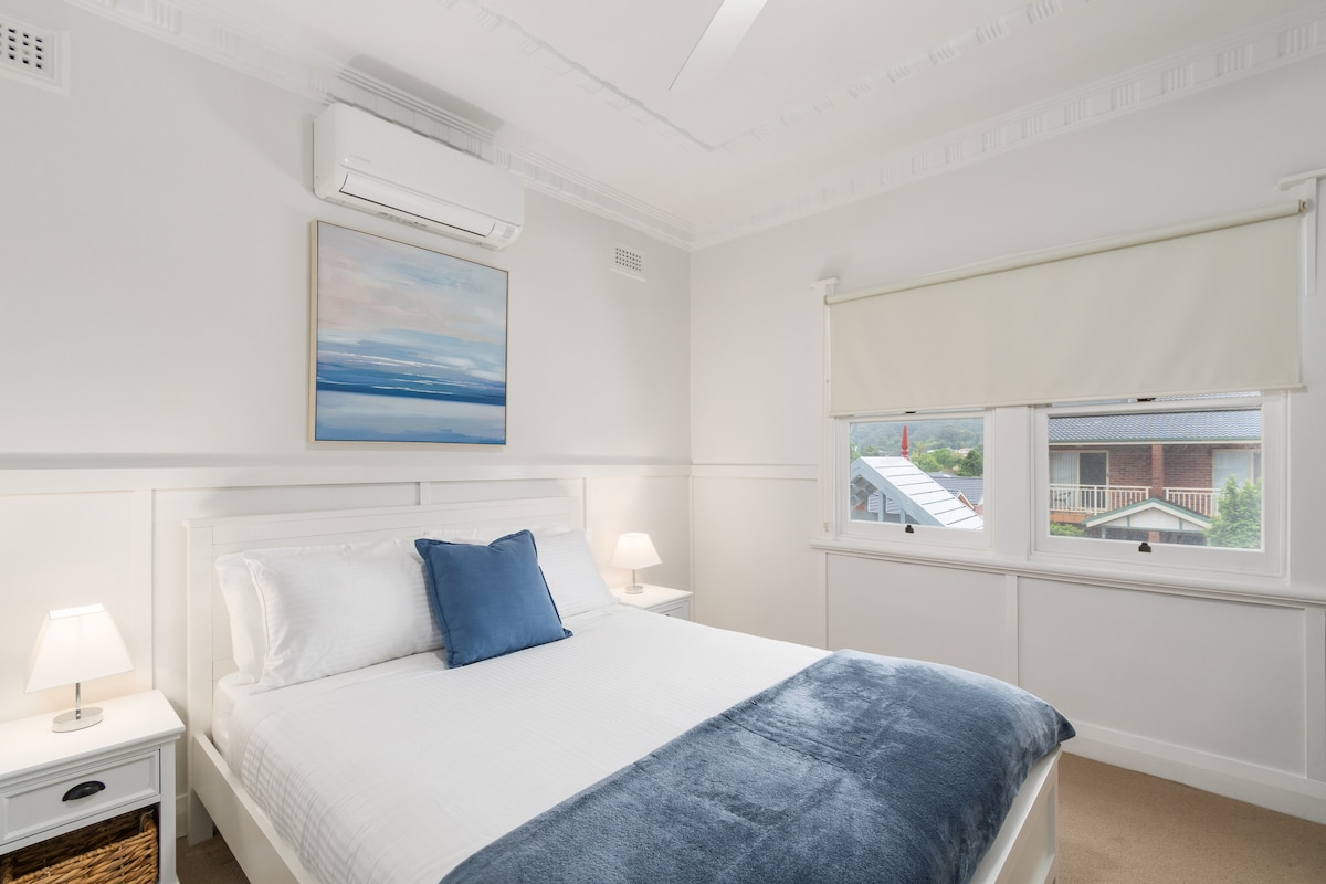 Unwind in the cosy second bedroom, complete with a plush queen bed and a calming view through the large window.
