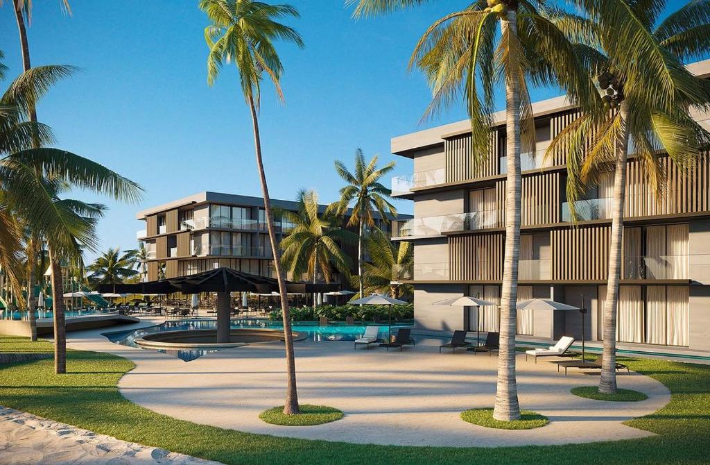 The exterior of Porto Alto Resorts is highlighted by modern buildings surrounded by lush palm trees. A sunlit pool area features lounge chairs and a shaded cabana, with manicured lawns providing a serene setting for relaxation and leisure.