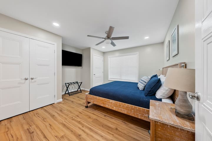 Primary suite with private bath featuring heated tile floor, located on main level. 