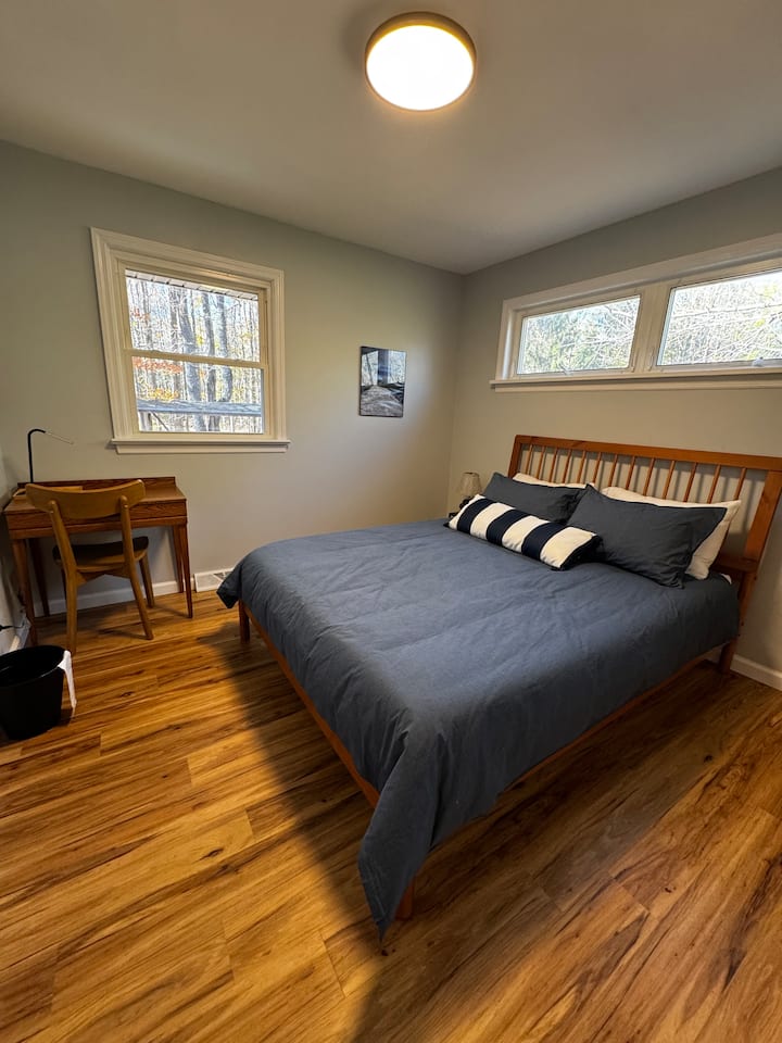 Bedroom 2 with queen bed and desk.