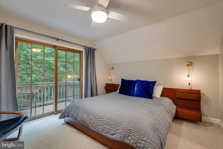Bedroom 5: King bedroom with Smart TV and a small deck off the back with seating for 2
