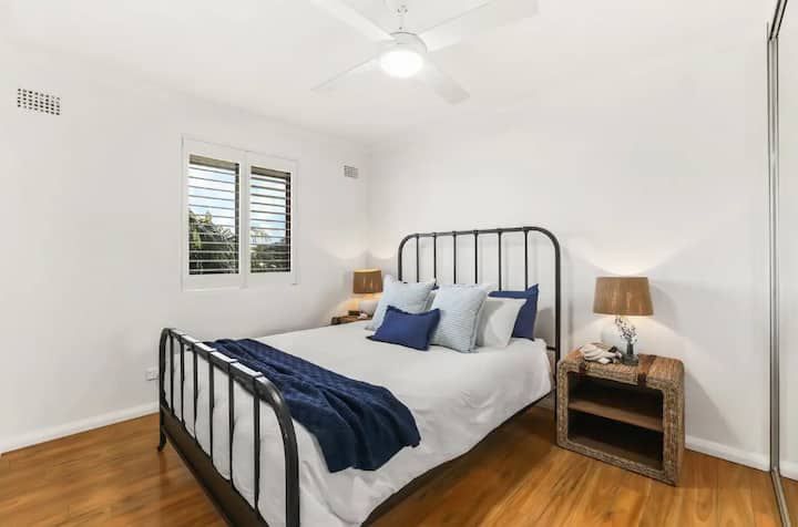 Comfortable queen bed with large wardrobe.