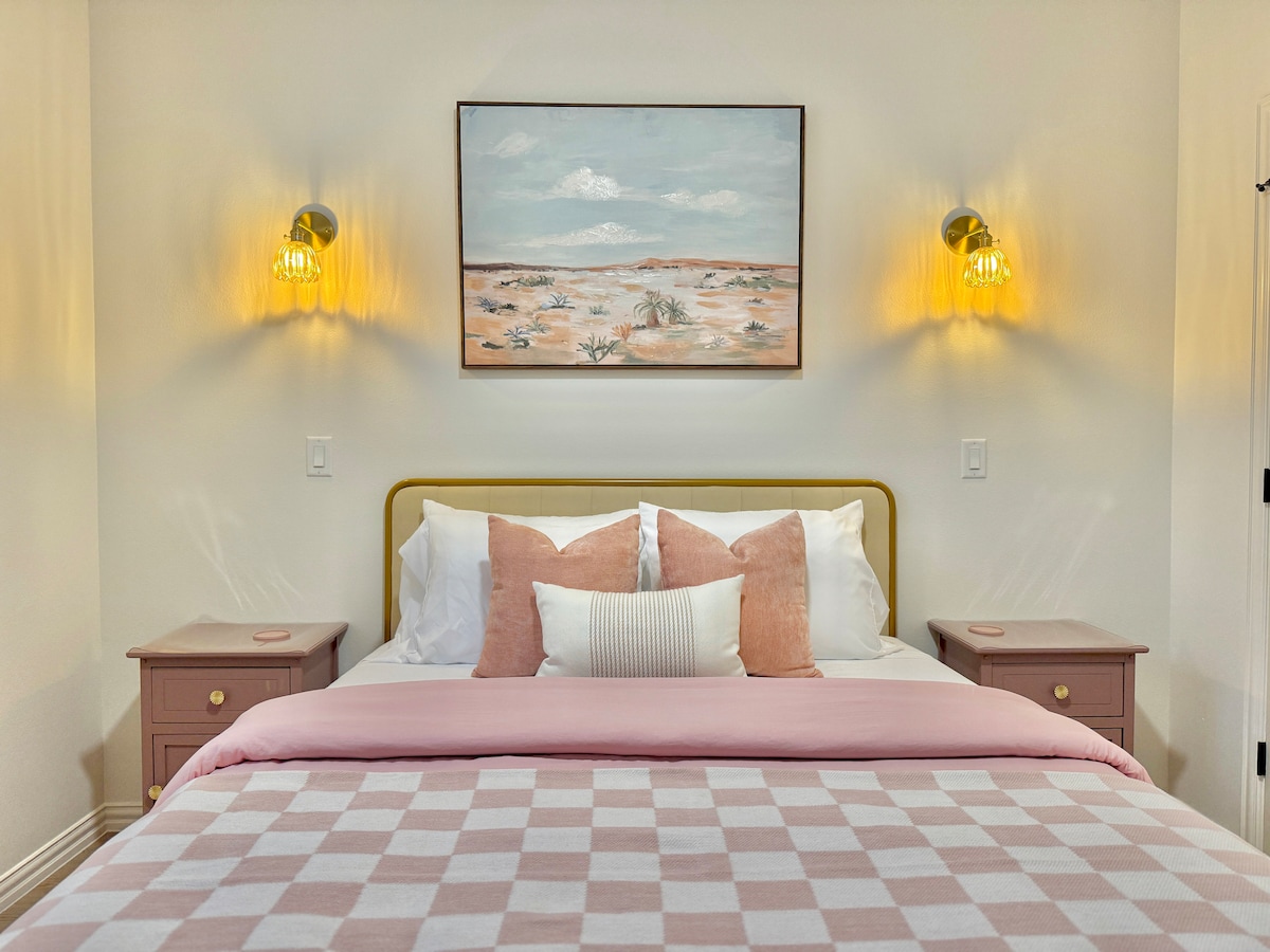 Settle into the guest bedroom with a plush queen-sized bed, topped with cozy pink blankets for ultimate comfort. A perfect retreat for relaxation!