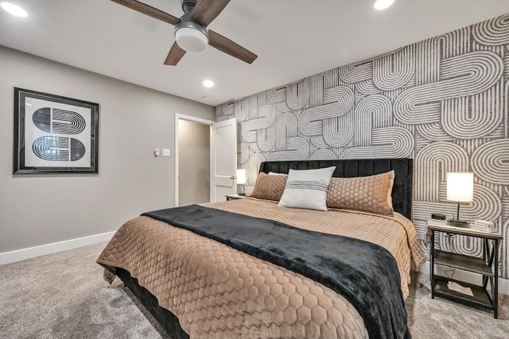 The master bedroom has a brand new King bed/mattress, 50" smart TV, noise machine, blue tooth speaker, large closet and attached bathroom/laundry. 