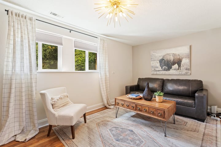 Downstairs living room that is connected to the laundry area as well as bathroom 2 and bedroom 2. 