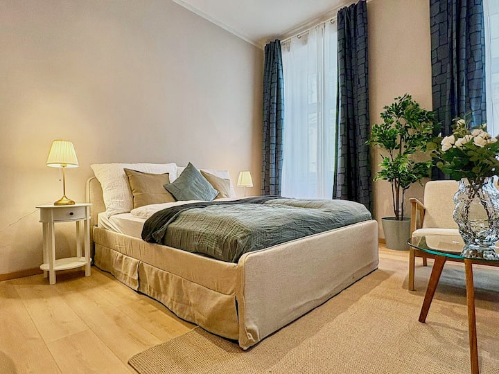 Chumba cha kulala cha kifahari kilicho na kitanda kikubwa, kilichozungukwa na rangi za kutuliza na nguo za starehe. Likizo bora kwa ajili ya mapumziko na mapumziko. 