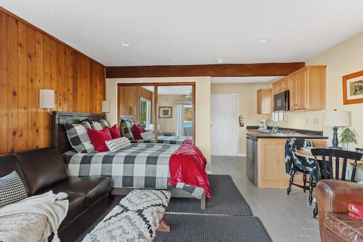 Third Bedroom is a stand-alone studio on the ground level, attached to house through garage. Studio faces lake for breathtaking views with walk out patio and Adirondack chairs.  
