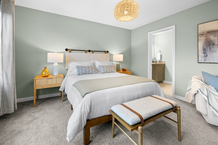 Comfortable master bedroom with a queen-sized bed, private balcony, and peekaboo views of Haystack Rock and the iconic dune. A perfect retreat for relaxation and enjoying the coastal scenery.
