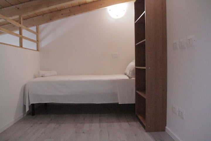 The upper level features a single bed and a bookshelf. You can also bring a chair, a folding table, or even an additional bed if desired.