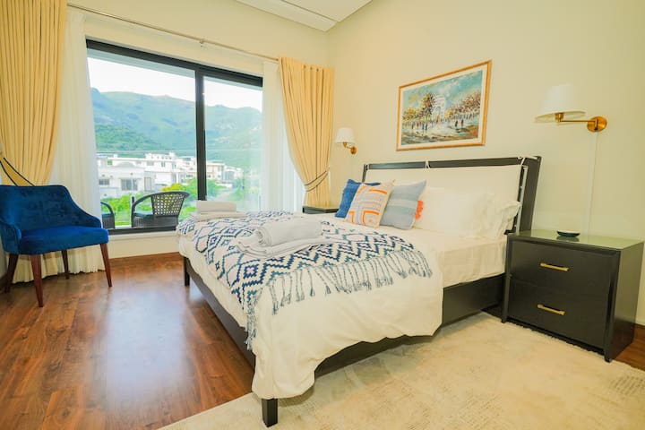 Entspanne dich in einem weichen Kingsize-Bett mit weicher Bettwäsche, Verdunkelungsvorhängen und einer ruhigen Atmosphäre für erholsame Nächte.