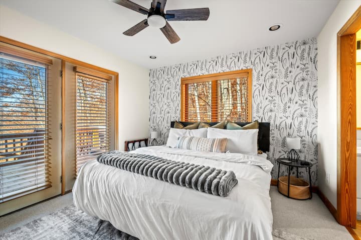 [Master Bedroom; Main Level]  King bed with master bathroom off to the right.  Quick entrance to the hot tub through the doors to the left. 