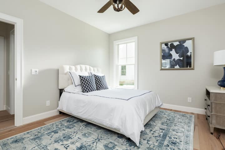 There's one bedroom (queen bed) downstairs just off the kitchen. (Blinds have been added since this picture!)