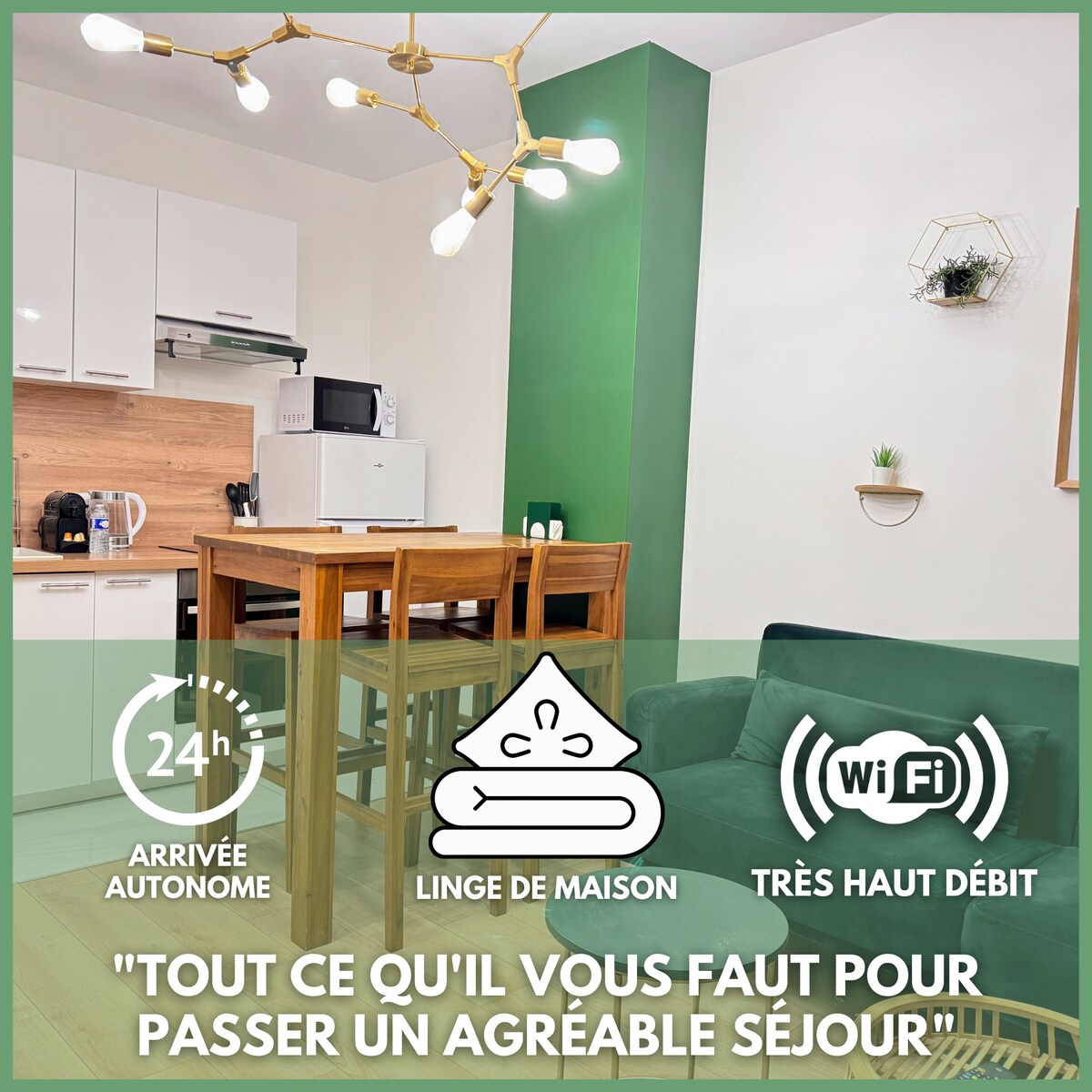 A welcoming living space features a modern kitchen area with essential appliances including a microwave and refrigerator. A cozy dining table with high stools is visible alongside a dark green accent wall. A comfortable sofa provides a relaxing seating option, and ample natural light brightens the room.