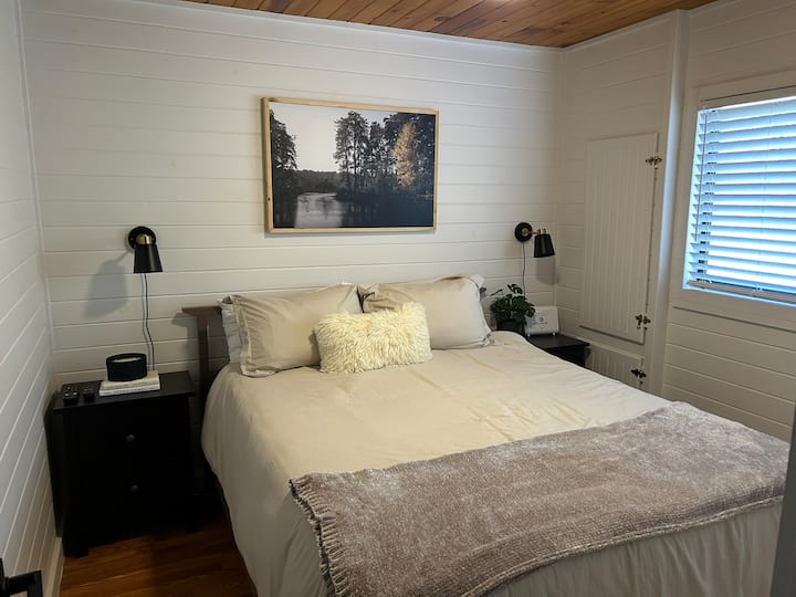 Spálňa 1 s manželskou posteľou a nočnými stojanmi s úložným priestorom.