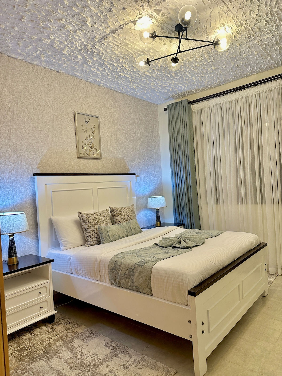 Rest in a cozy and inviting bedroom designed for ultimate comfort, complete with soft linens, ample storage, and a tranquil ambiance to ensure a peaceful night's sleep.