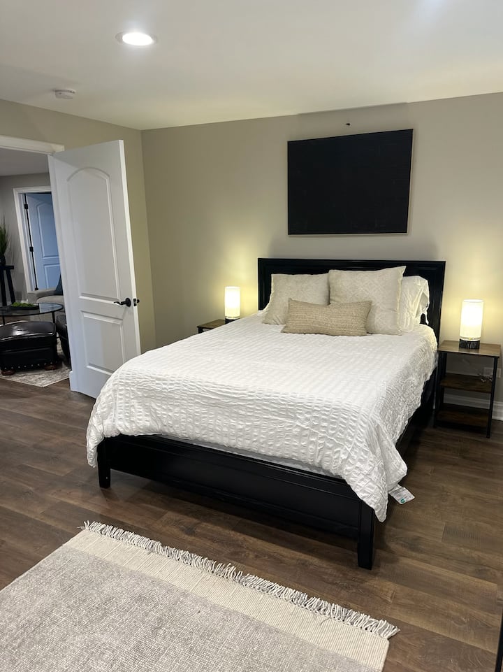 {GUEST BEDROOM} The guest bedroom offers a comfortable queen-size bed, closet, and dresser, providing a cozy and functional space for your stay.