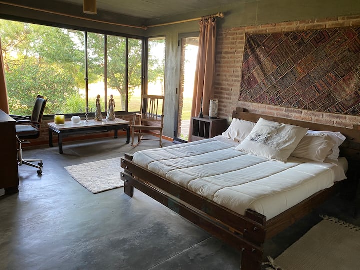 The master bedroom with wood stove and separate exit to the deck.