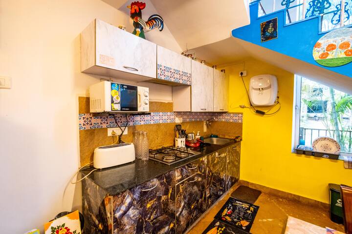 Well-equipped kitchen with essential appliances and utensils, ideal for light cooking or meal prep.