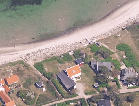 Large private cottage 1st row to a good beach