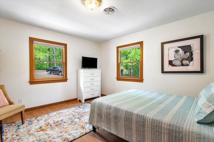 Fourth bedroom on upper floor with flat-screen Roku TV and queen bed.