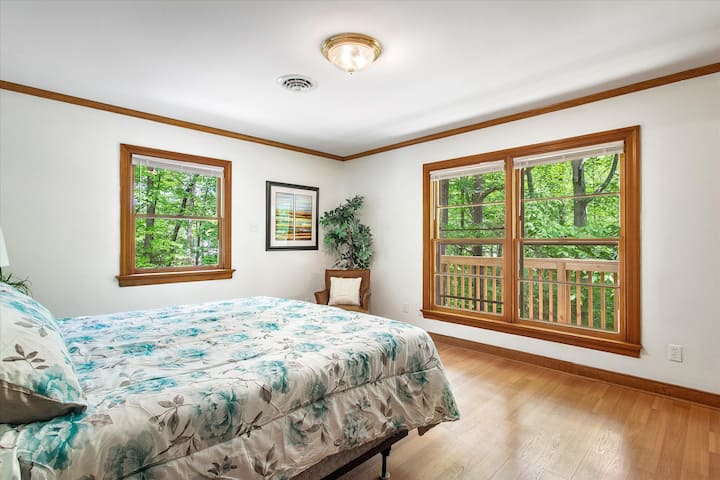 Primary master bedroom on upper floor with king bed, walk-in closet, dresser space, flat-screen Roku TV and ensuite full bathroom with stand up shower.