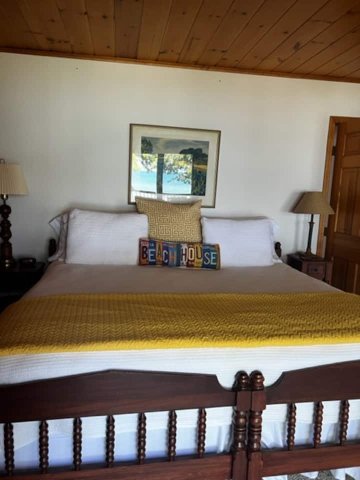 King Bed in Main Guest Suite with Lake MI reflected in the picture.