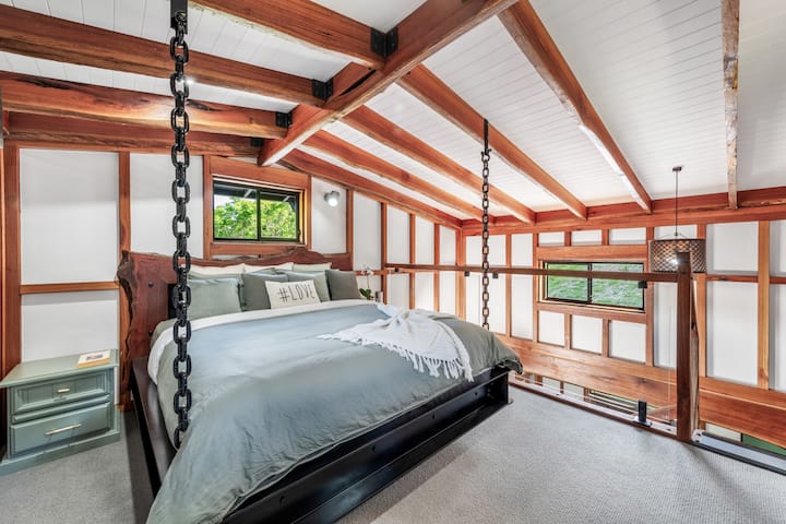 King size primary bed with TV in bedroom