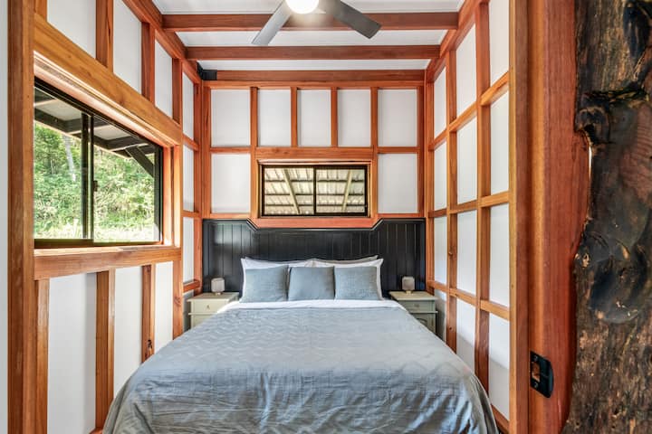 Queen bed with TV in bedroom