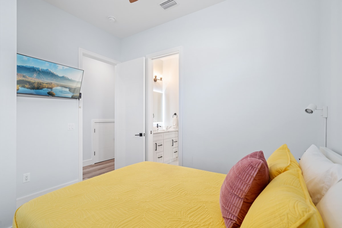 Druhá spálňa s manželskou posteľou Queen na prízemí s kúpeľňou typu jack a jill a veľkým inteligentným televízorom