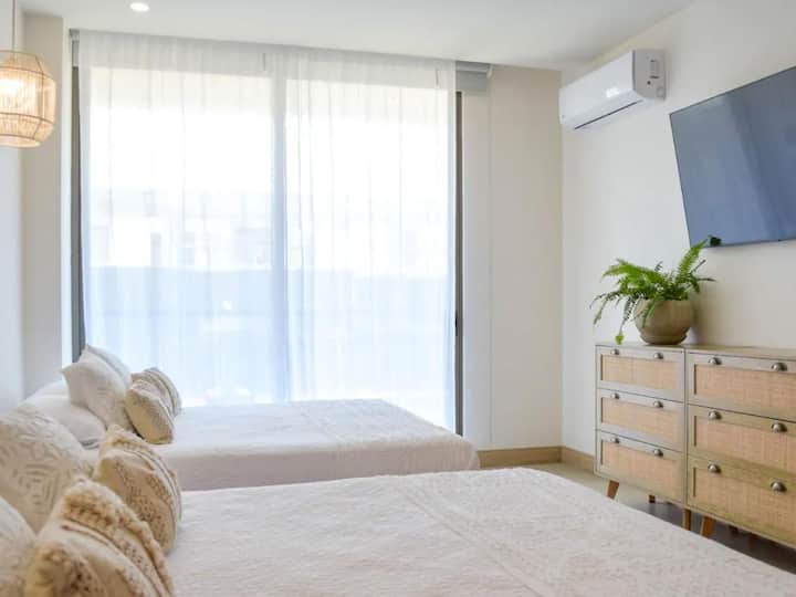 استمتع بنوم هانئ في سريرين مريحين. الغرفة مشرقة وتحتوي على تلفزيون ذكي وستائر تعتيم لضمان راحتك. مثالية لما يصل إلى 4 ضيوف يسعون للحصول على أقصى درجات الراحة.