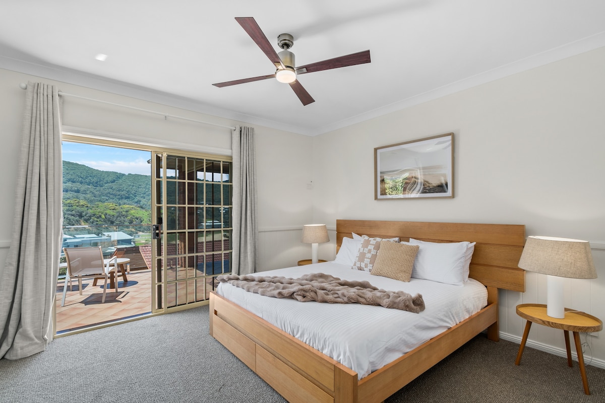 The thoughtfully appointed primary bedroom features a gorgeous king-size bed, an ensuite bathroom and direct access to the balcony. 