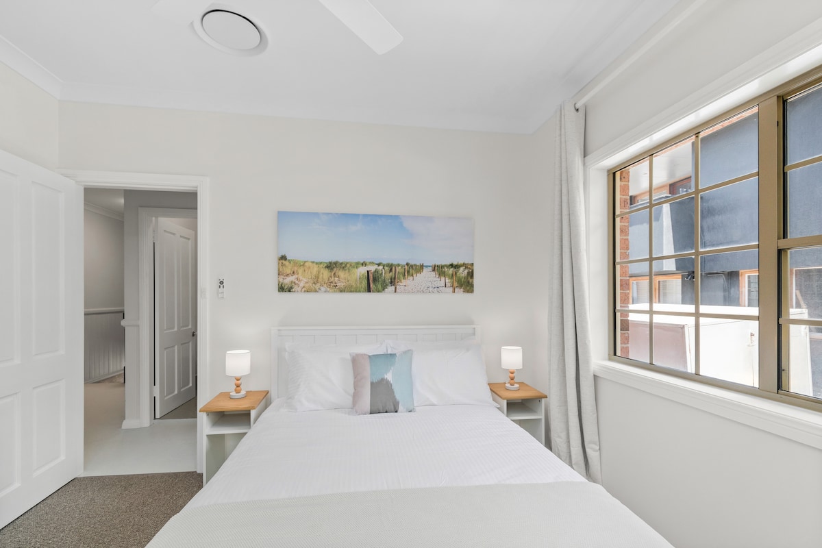 The light-filled third bedroom includes a queen-size bed, with ceiling fans in all five bedrooms.
