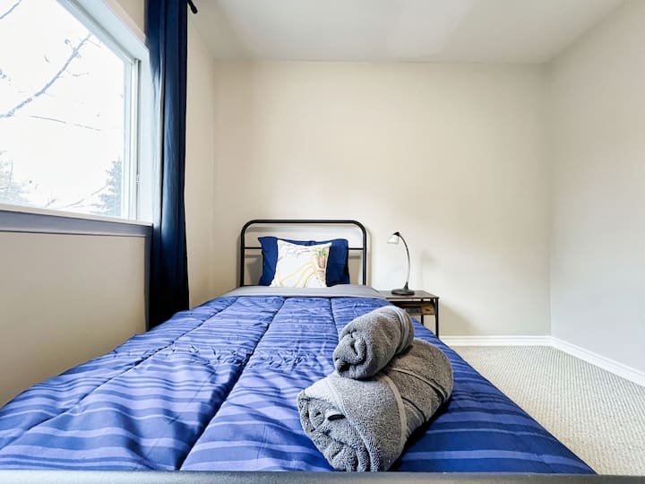 Spacious bedroom featuring a comfortable single bed, offering plenty of room to relax and unwind.