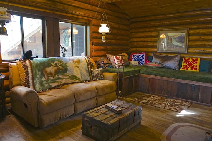Main Cabin: Living room space with an open floor plan to the half bathroom, kitchen, dining room and deck. 
