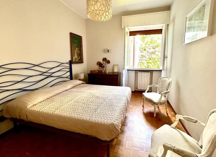 غرفة نوم رئيسية بسرير بحجم كوين وخزانة واسعة ومساحة درج