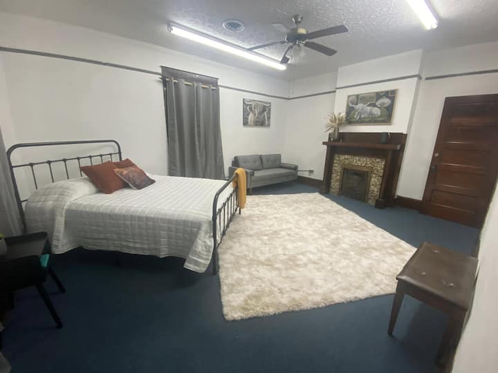 Bedroom with queen bed, sofa and large walk-in closet.