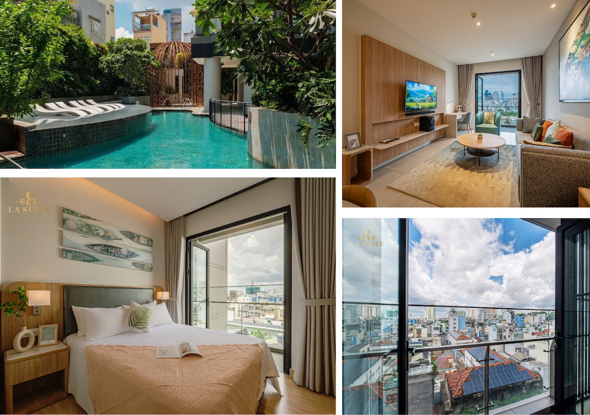 A refreshing outdoor pool is surrounded by lush greenery and sun loungers, creating a serene space for relaxation. The inviting living room features a wall-mounted TV, comfortable seating, and large windows that offer views of the city. A cozy bedroom boasts a spacious bed and access to a private balcony, providing picturesque city sights.