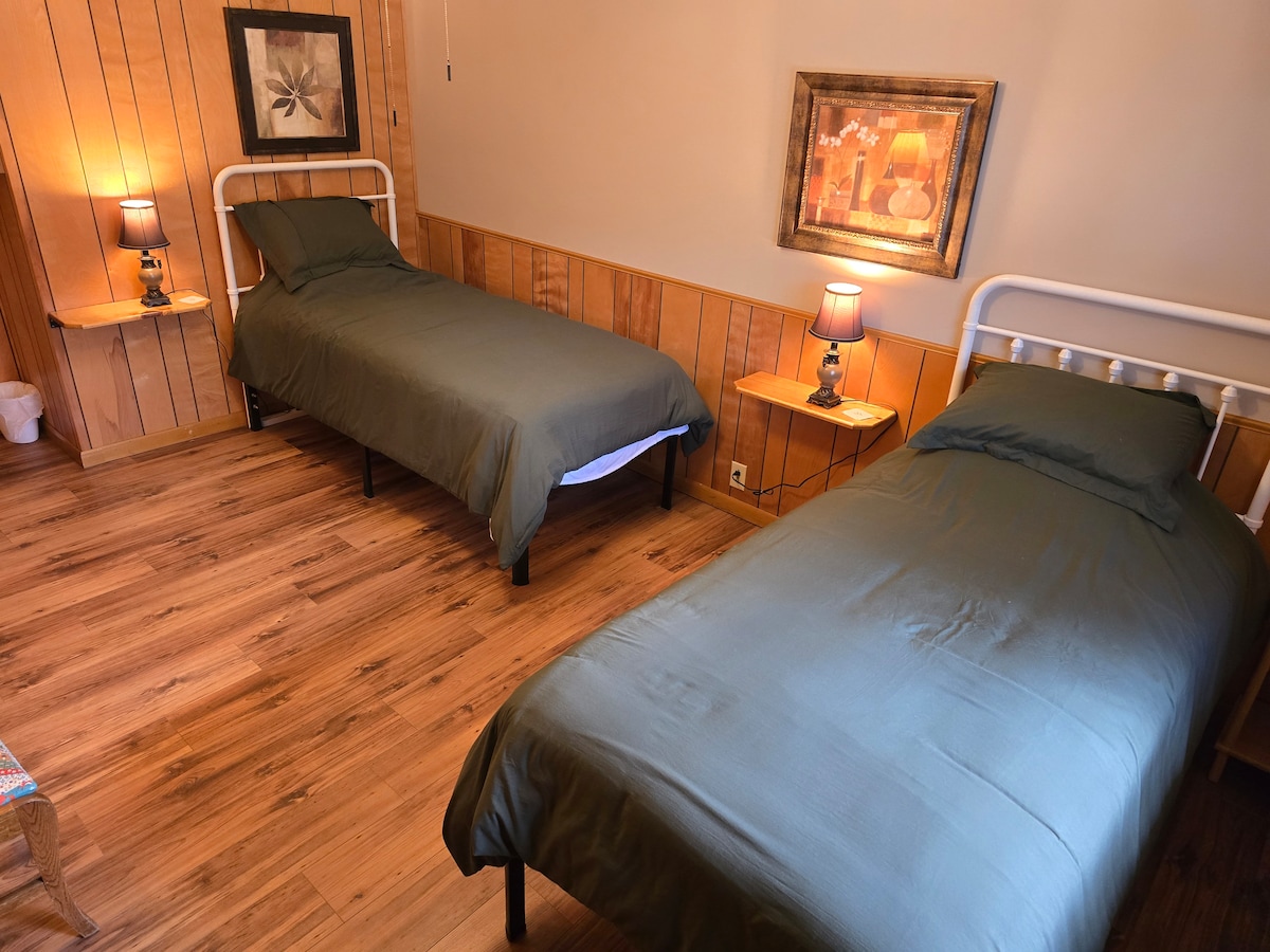 Bedroom nearest kitchen, ft two twin-XL beds, ceiling fan, walk in closet, looking out over the Ouachita River.  